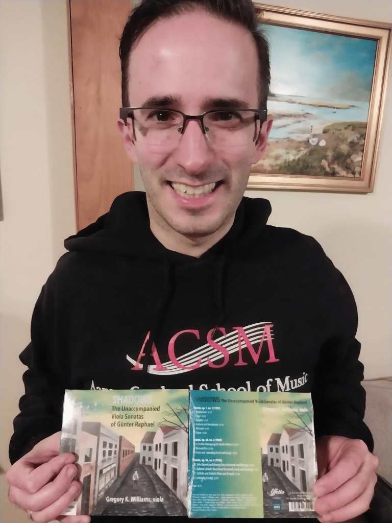 Gregory Williams holding the front and back of SHADOWS; his debut album